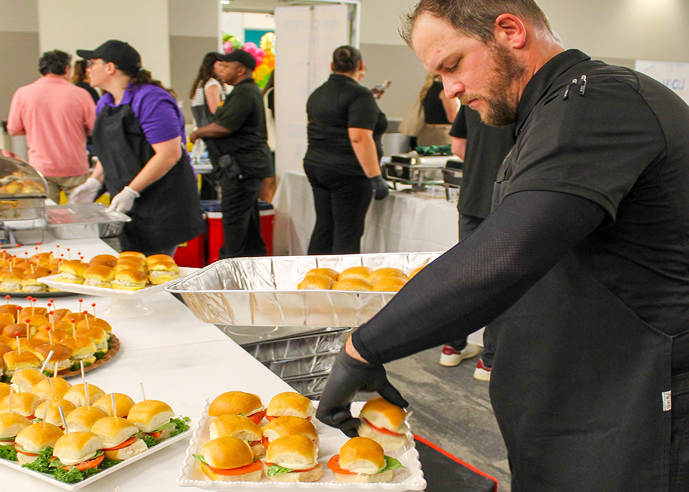 GRG catering staff preparing slider trays for a corporate event